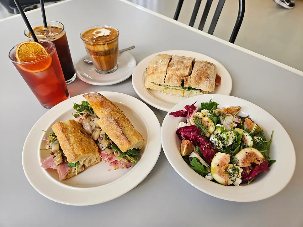 Drinks and brunch dishes on a table at Baut