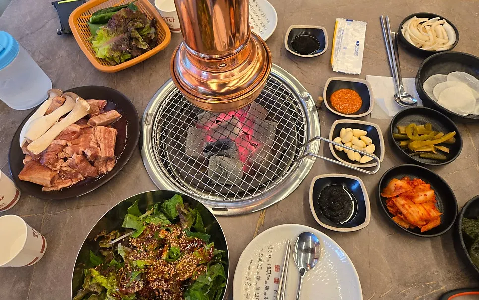 Basic side dish spread with lettuce, kimchi, and perilla leaf salad