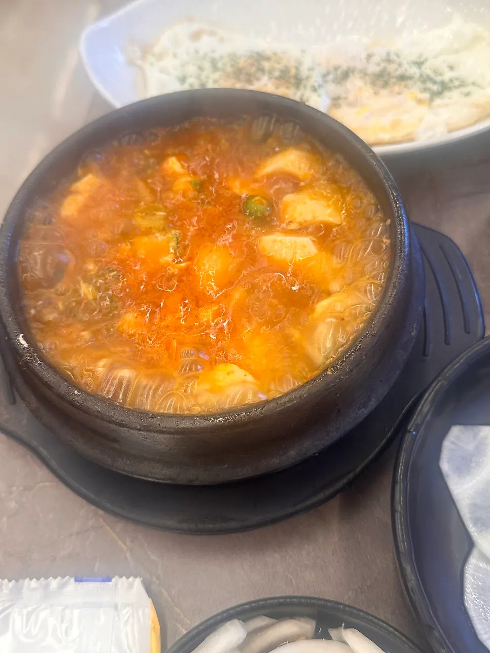Free soft tofu stew bubbling in a stone pot