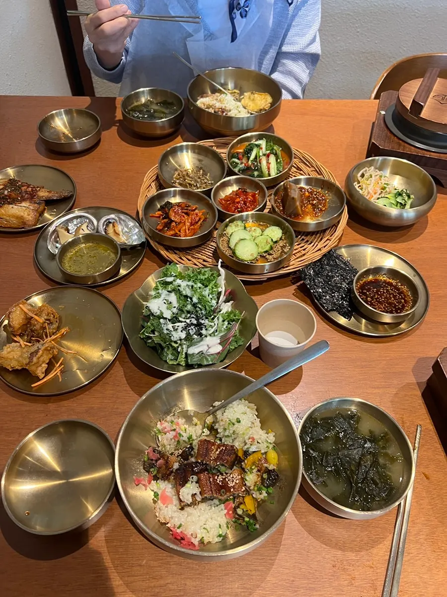 A bite of eel placed over abalone rice