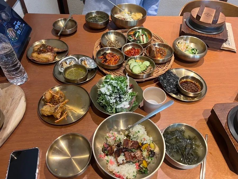 A full spread of main pot rice, side dishes, and soup