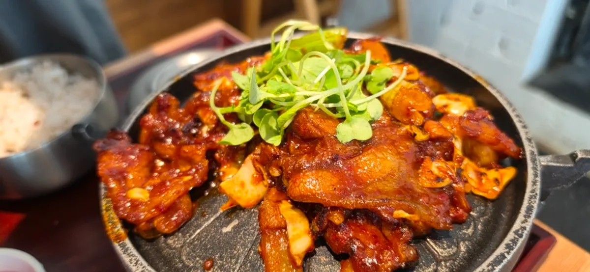 Grilled jeyuk bokkeum Korean set on a personal tabletop grill