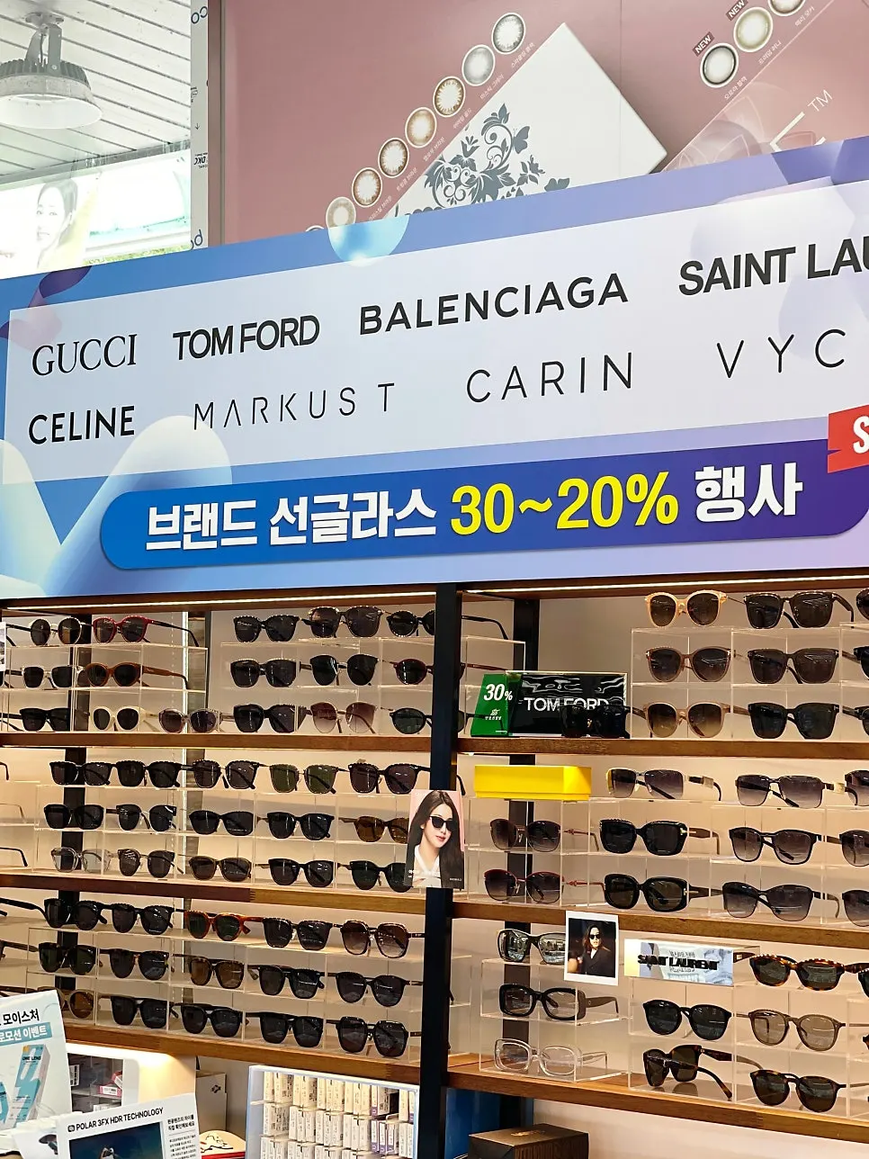 Display of luxury sunglasses including Tom Ford and Gucci