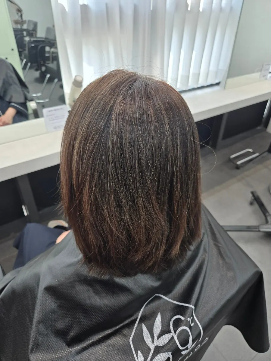 Patchy hair with visible gray hairs before the color treatment