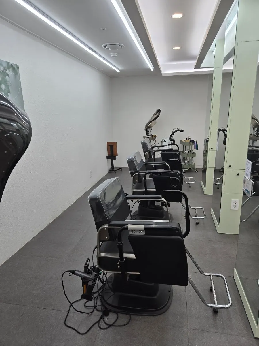 Interior of the hair salon decorated in white tones and wood