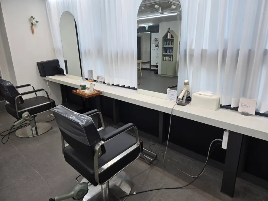 Row of styling chairs and mirrors inside the salon