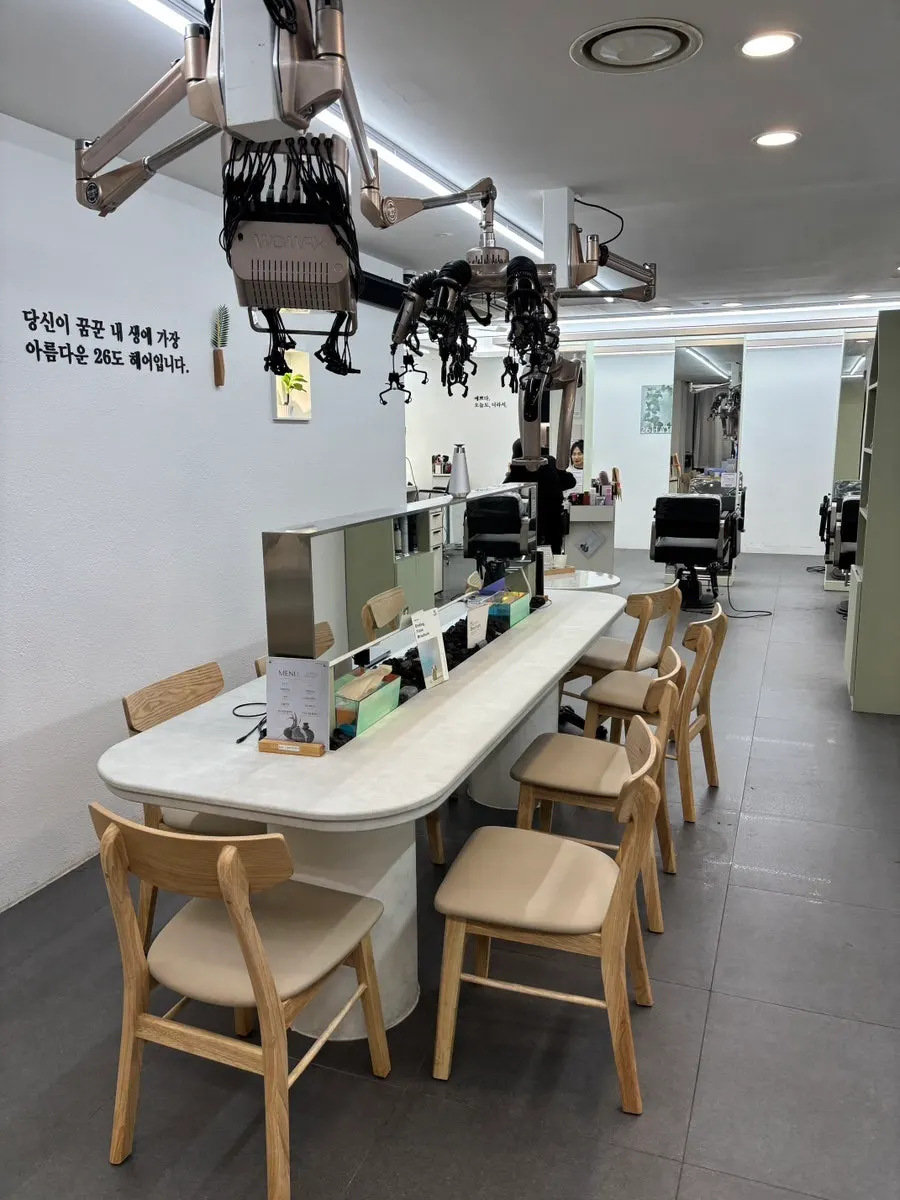 Salon interior with white tones and wood accents