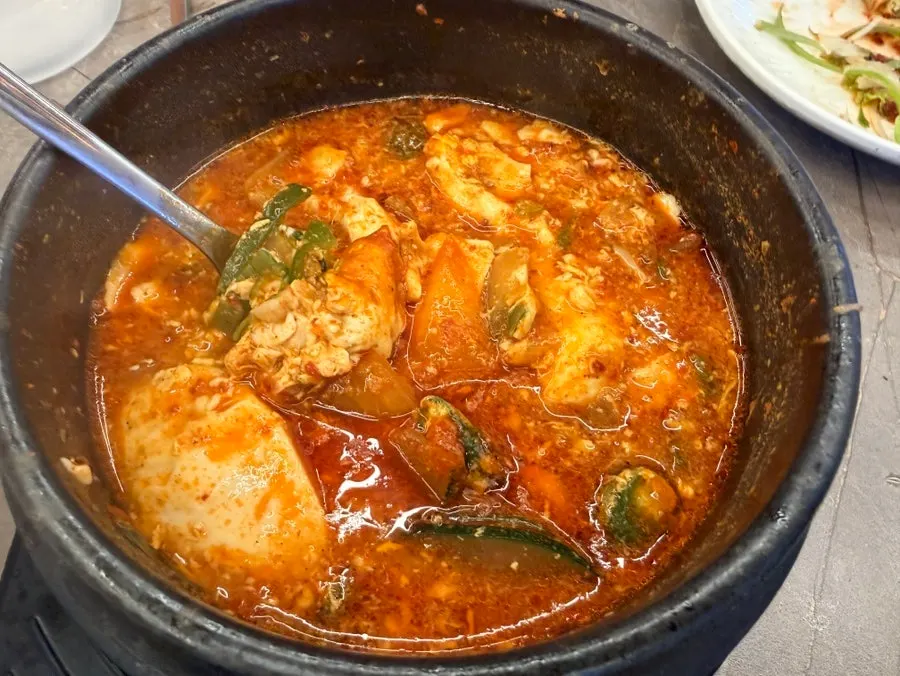 Spooning up the sundubu jjigae broth