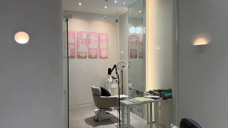 Salon space with paintings on display