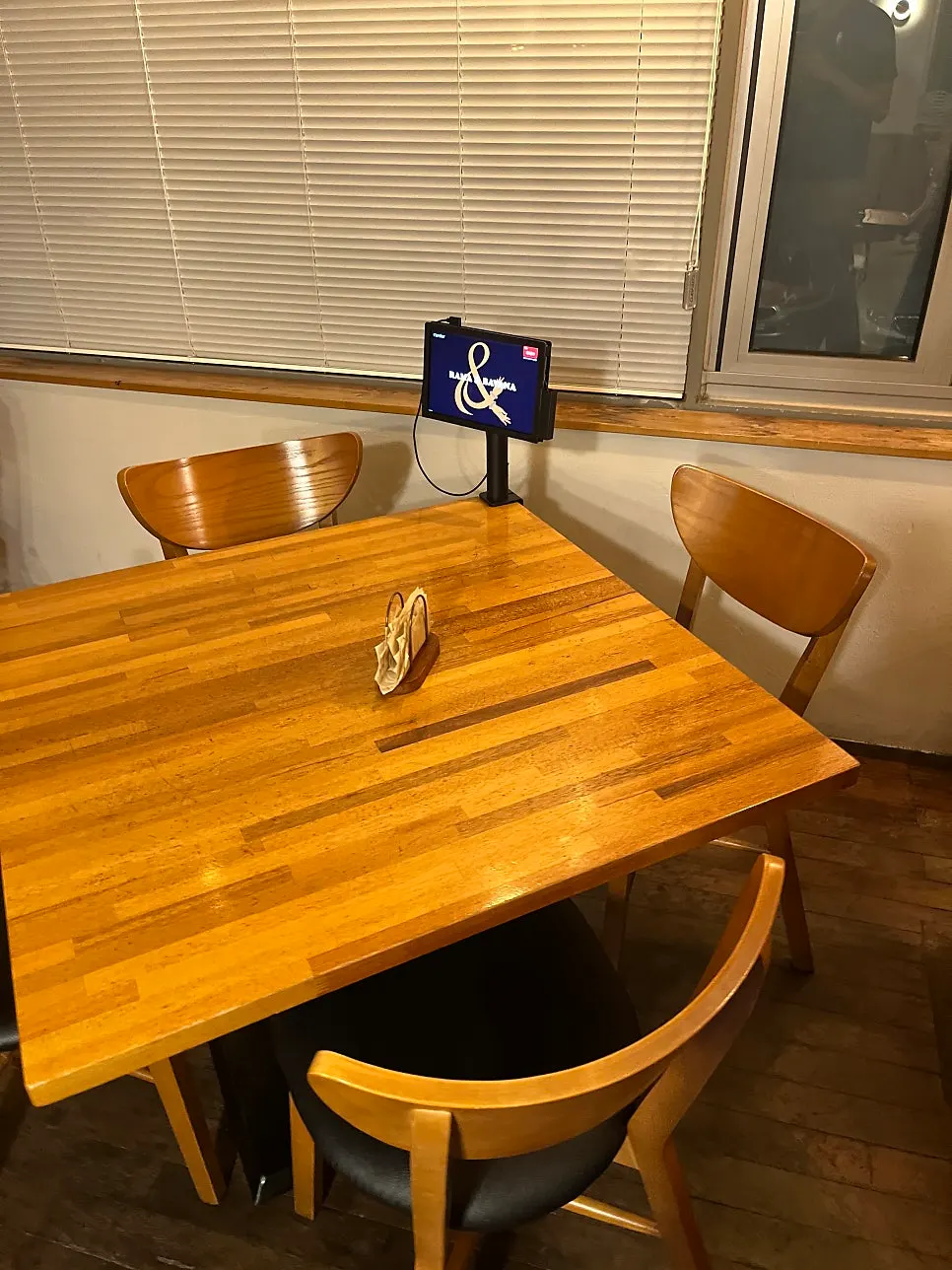 Wall with English logo and wooden waiting chairs