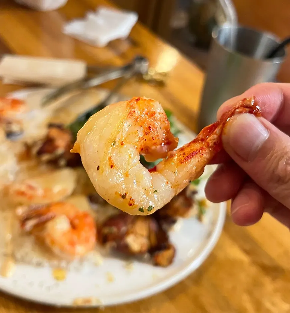 A plate of tandoori tikka with chicken and shrimp skewers