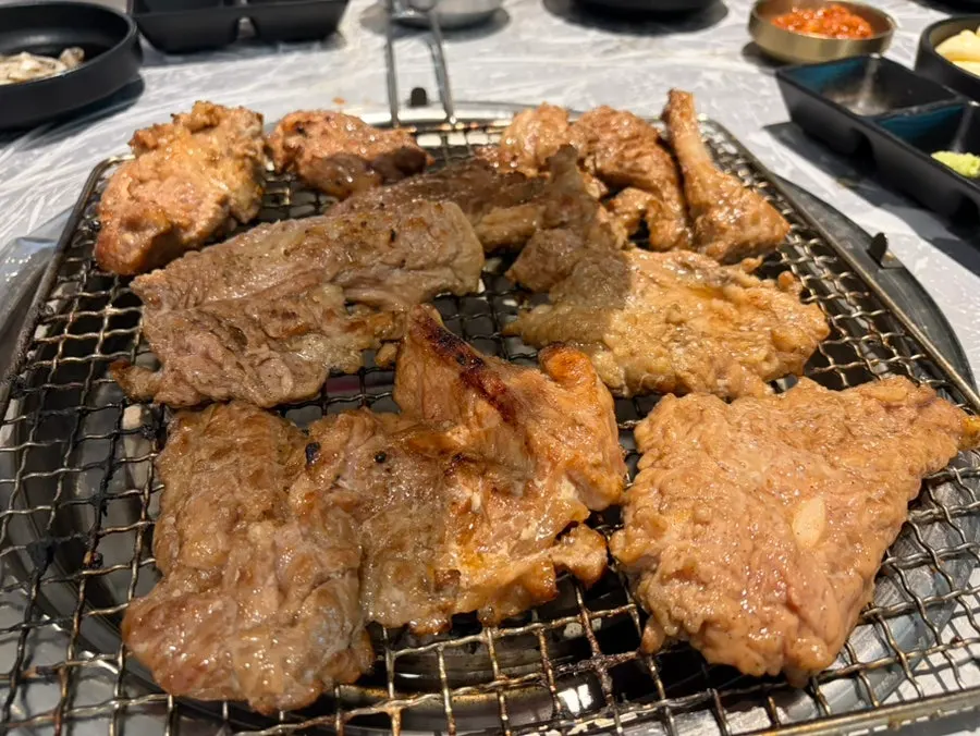 Staff pre-grilling the pork galbi tableside