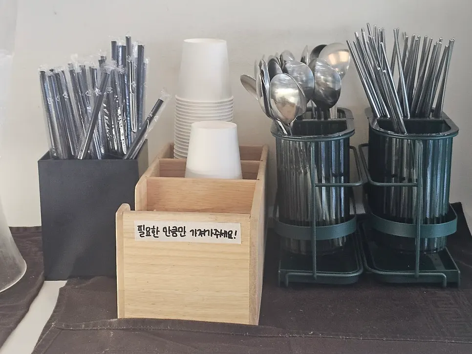 Self-service station with utensils and cups