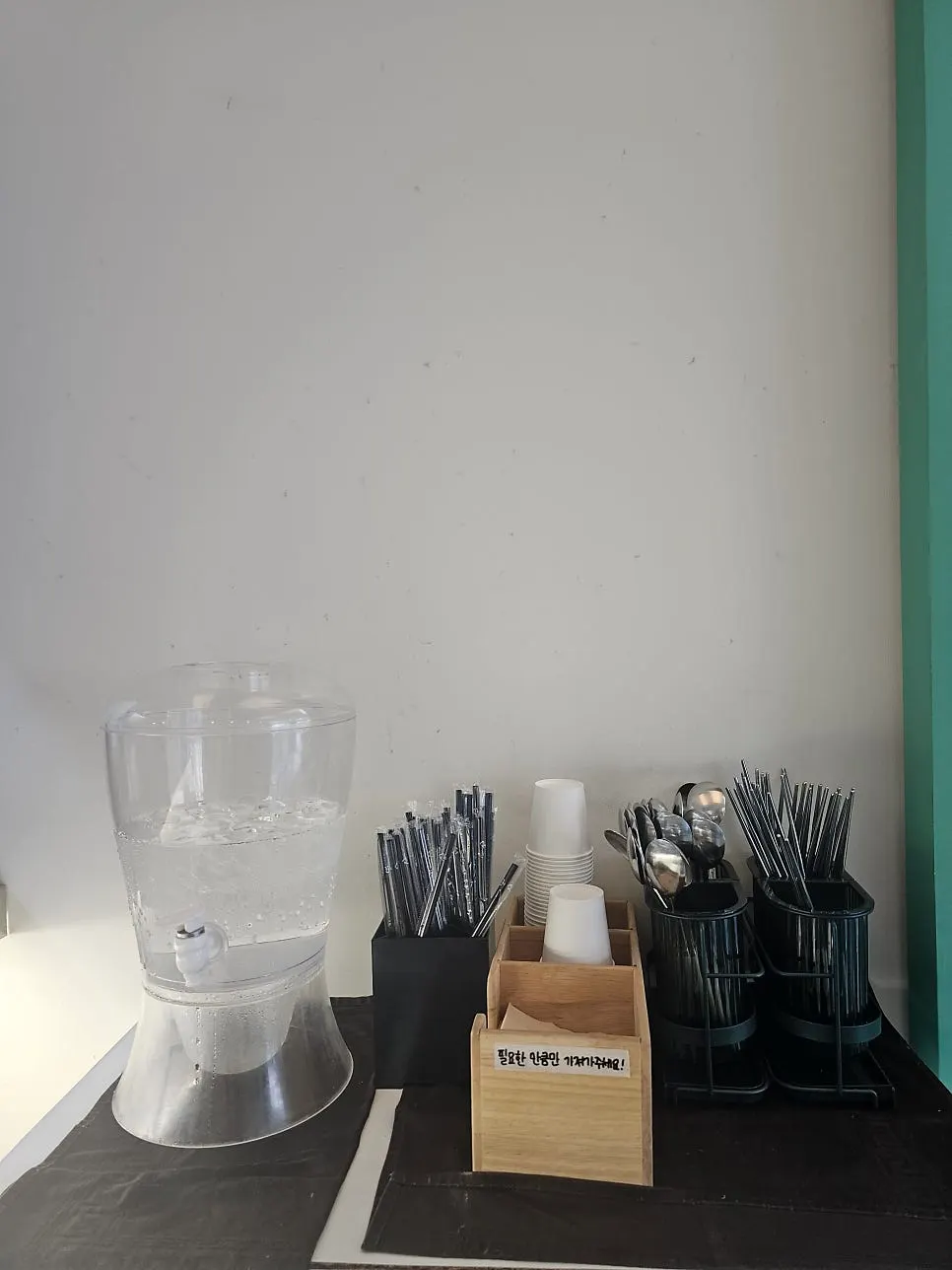 Self-service station with utensils and cups