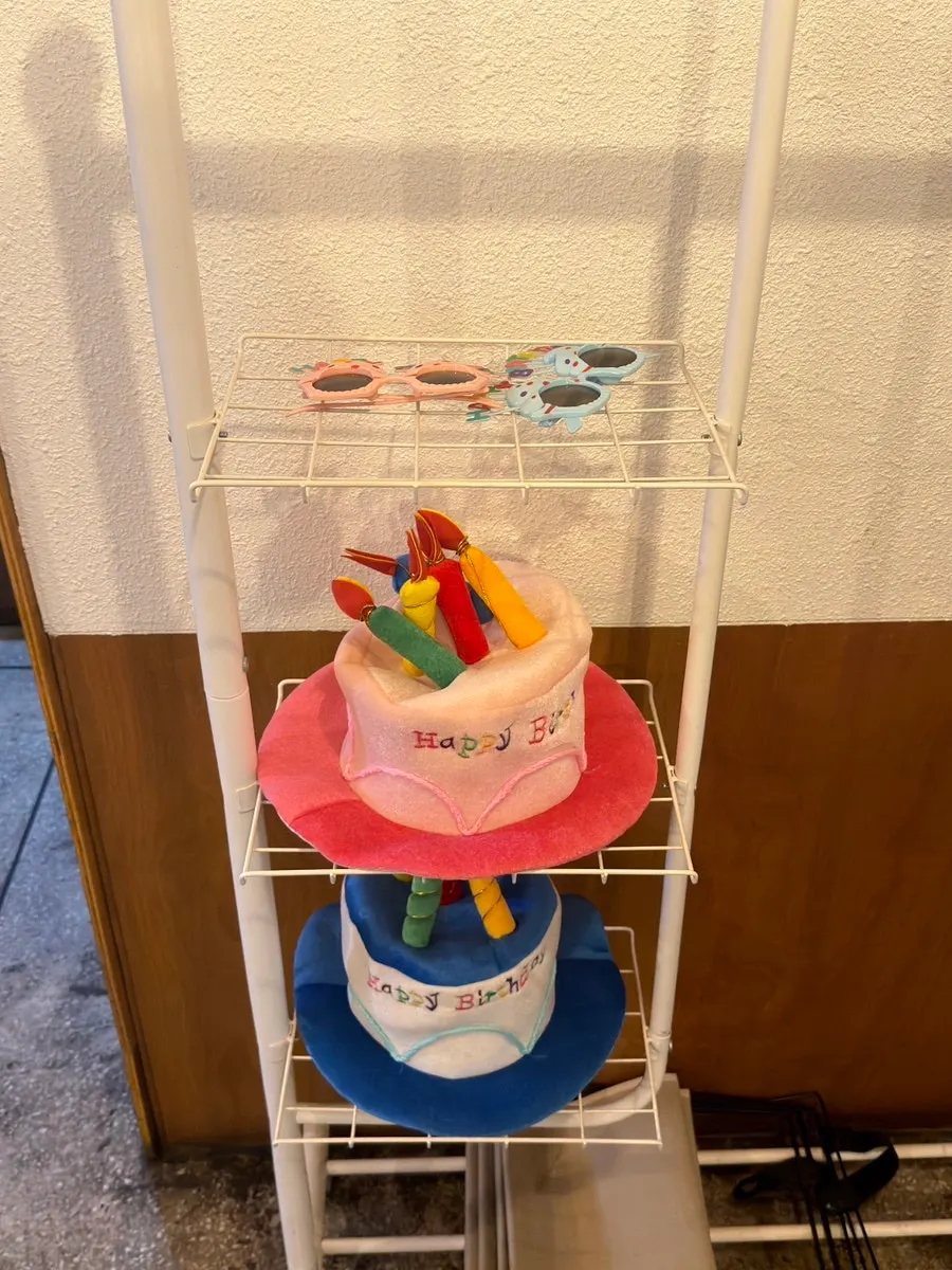 Party supply corner with birthday hats and sunglasses