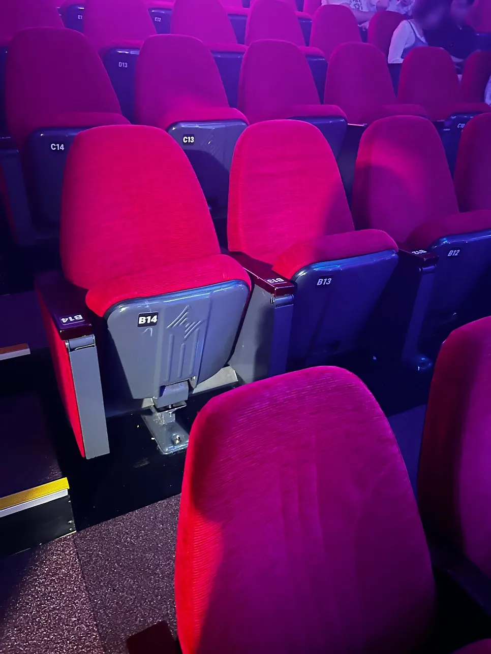 Movie-theater-style cushioned seating at Nine Theater