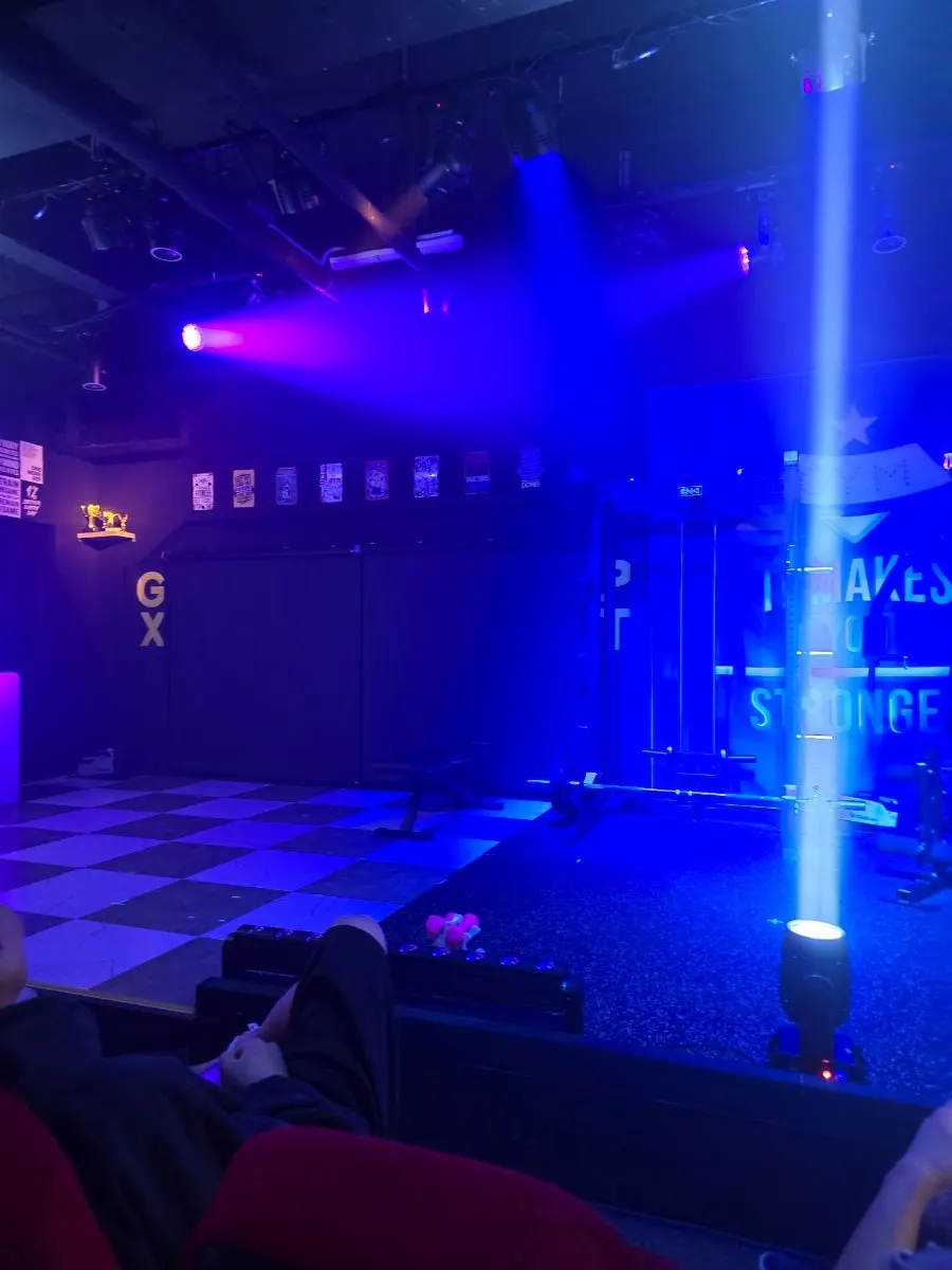 Suspicious PT Shop stage set with gym equipment