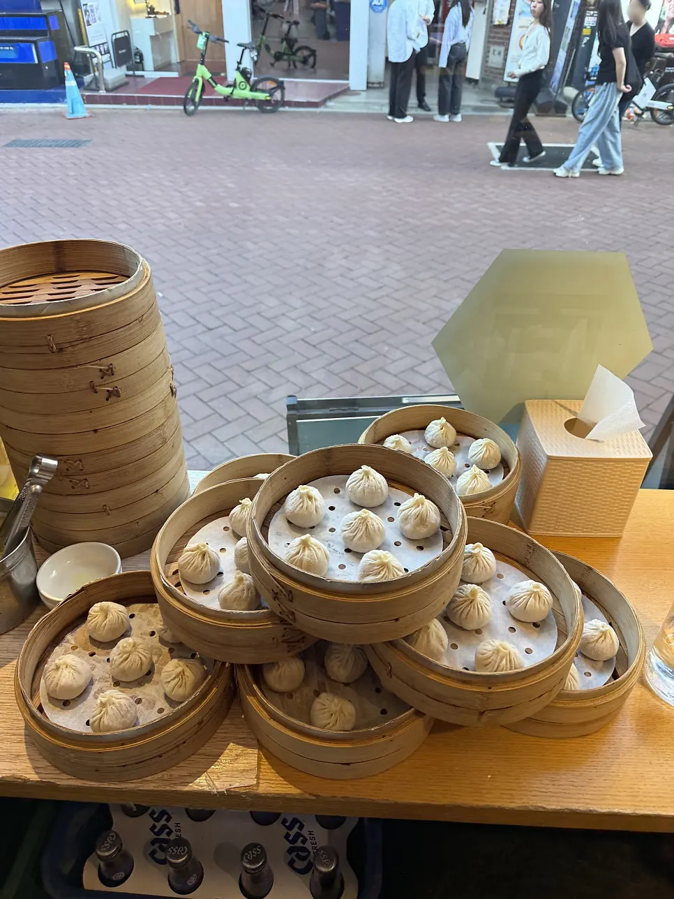 Table with dim sum and dipping sauce