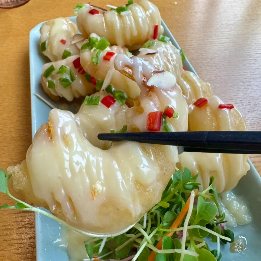Plate of cream shrimp with plenty of sauce on top