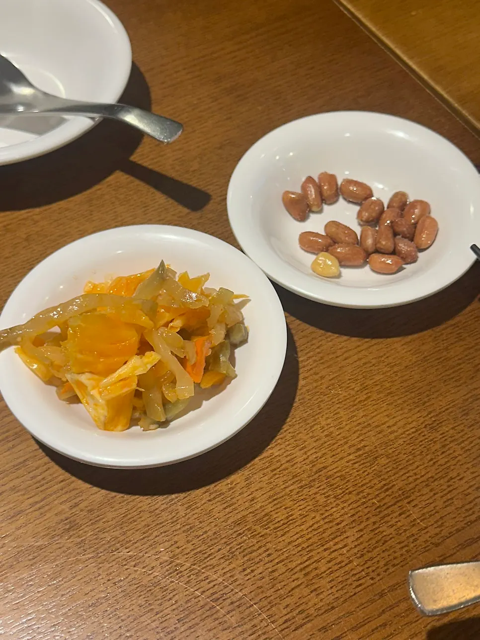 Two basic banchan, peanuts and pickled mustard greens