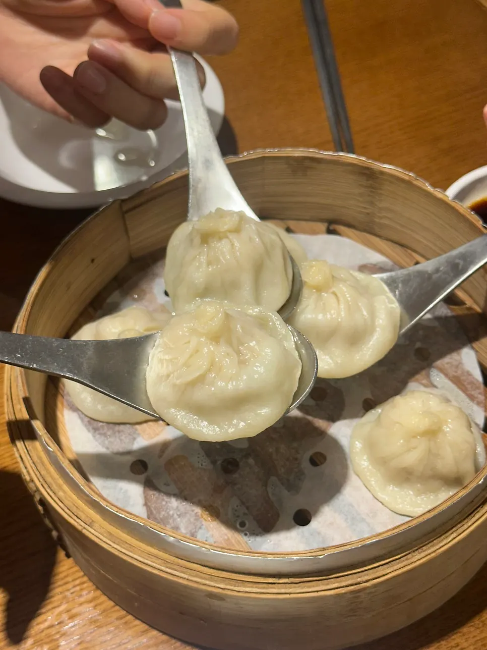 Xiaolongbao placed on a wide spoon