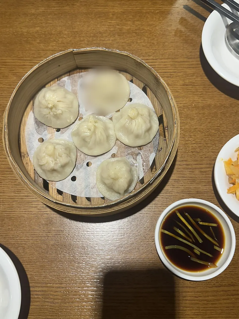 A bite of xiaolongbao dipped in sauce