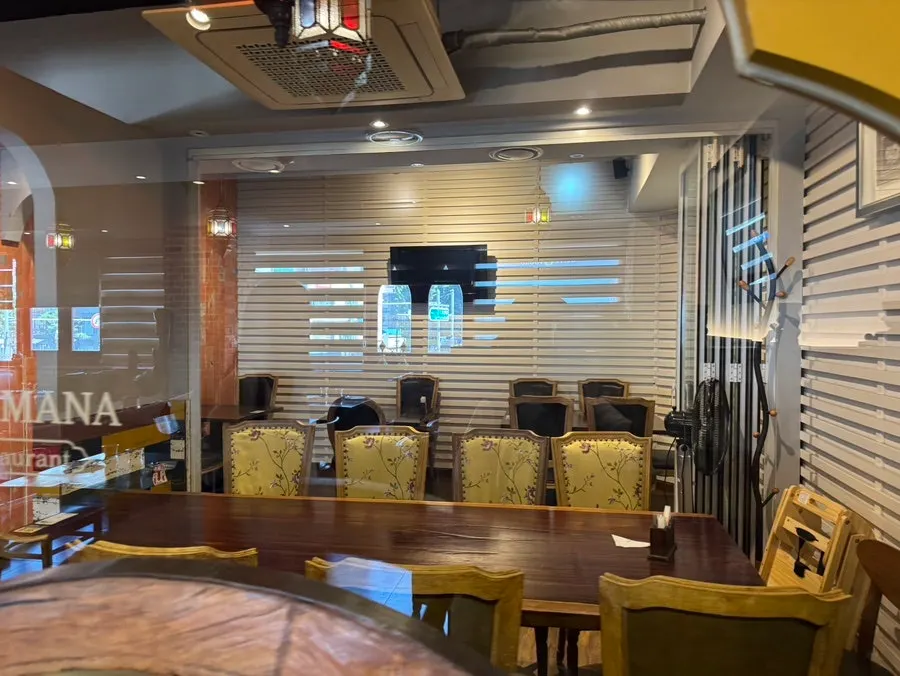 Restaurant entrance with red walls and traditional Indian sculptures