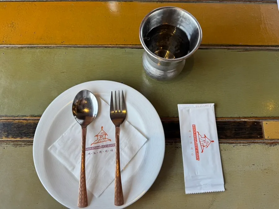 Seating with silverware set on wooden tables