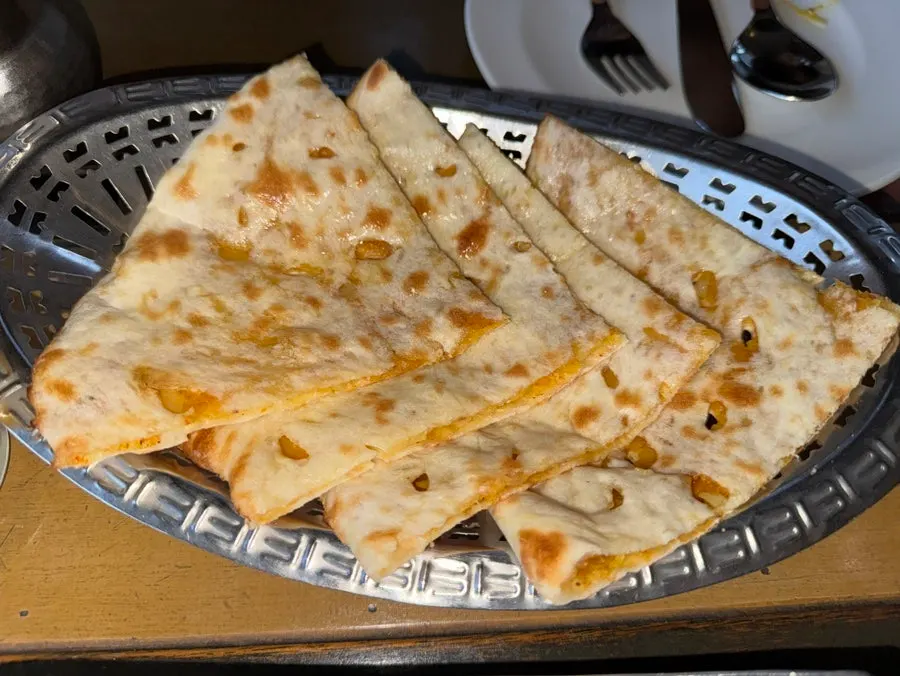 A torn-off piece of butter naan