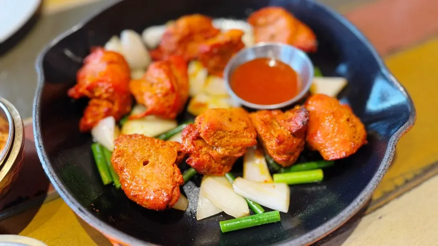 Close-up of chicken tikka grilled with vegetables