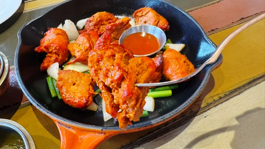 Cross-section of chicken tikka with a browned outside