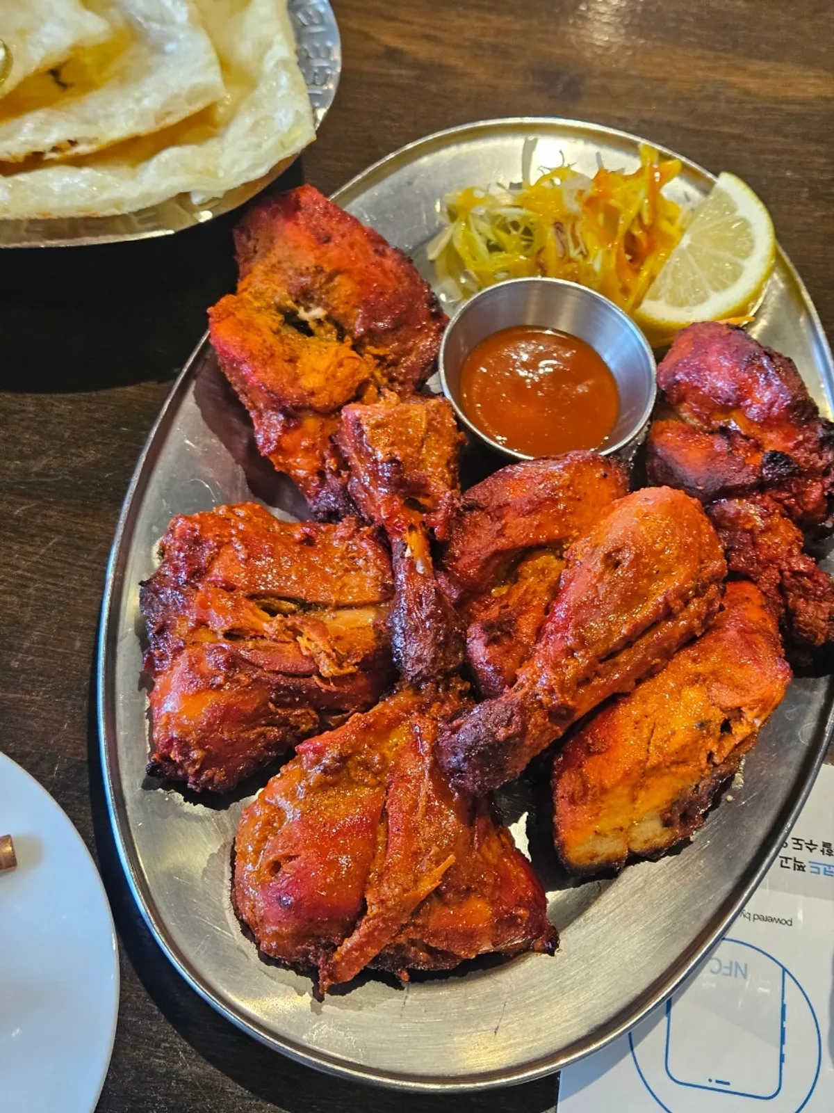 Tandoori chicken and curry pasta laid out on the table