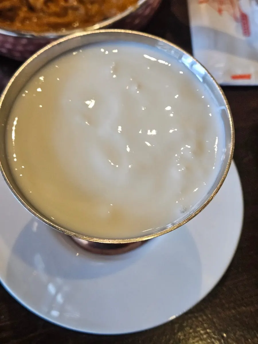 Torn butter naan dipped into curry sauce