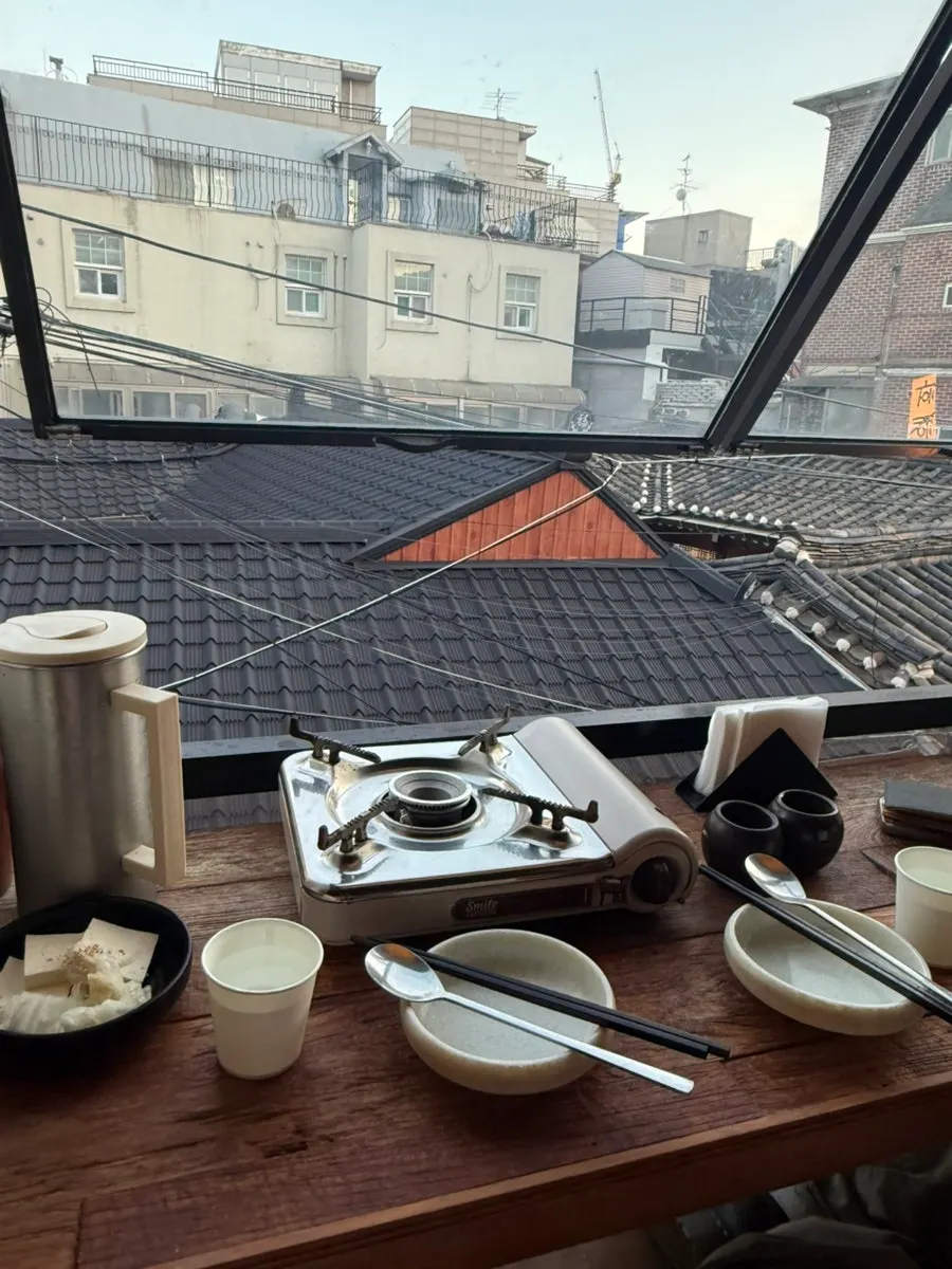 Window-side seat at Hyehwahwa with hanok-inspired charm