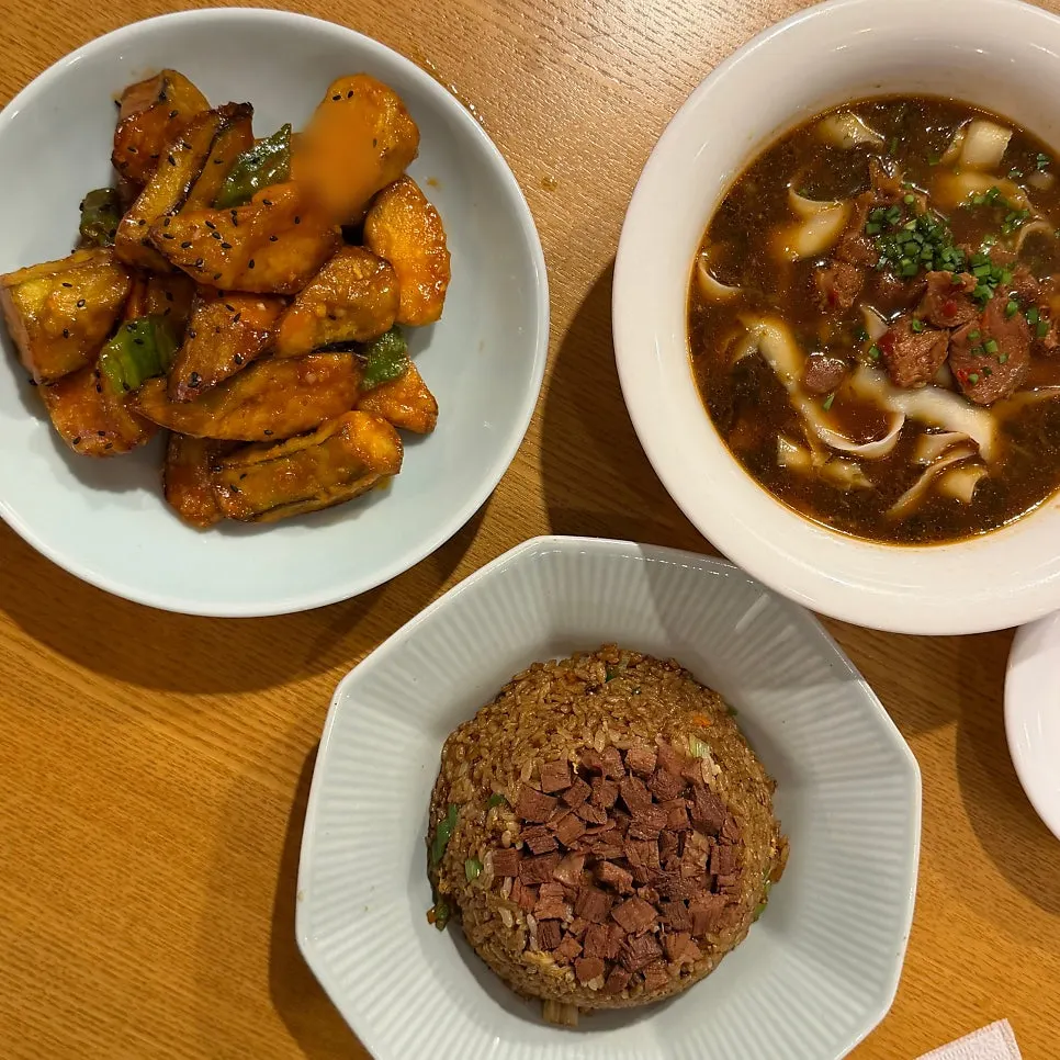 Table set with xiaolongbao and beef knife-cut noodles together