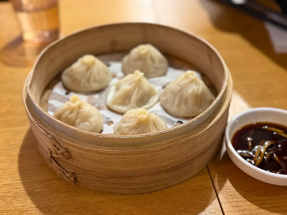 A xiaolongbao picked up with chopsticks