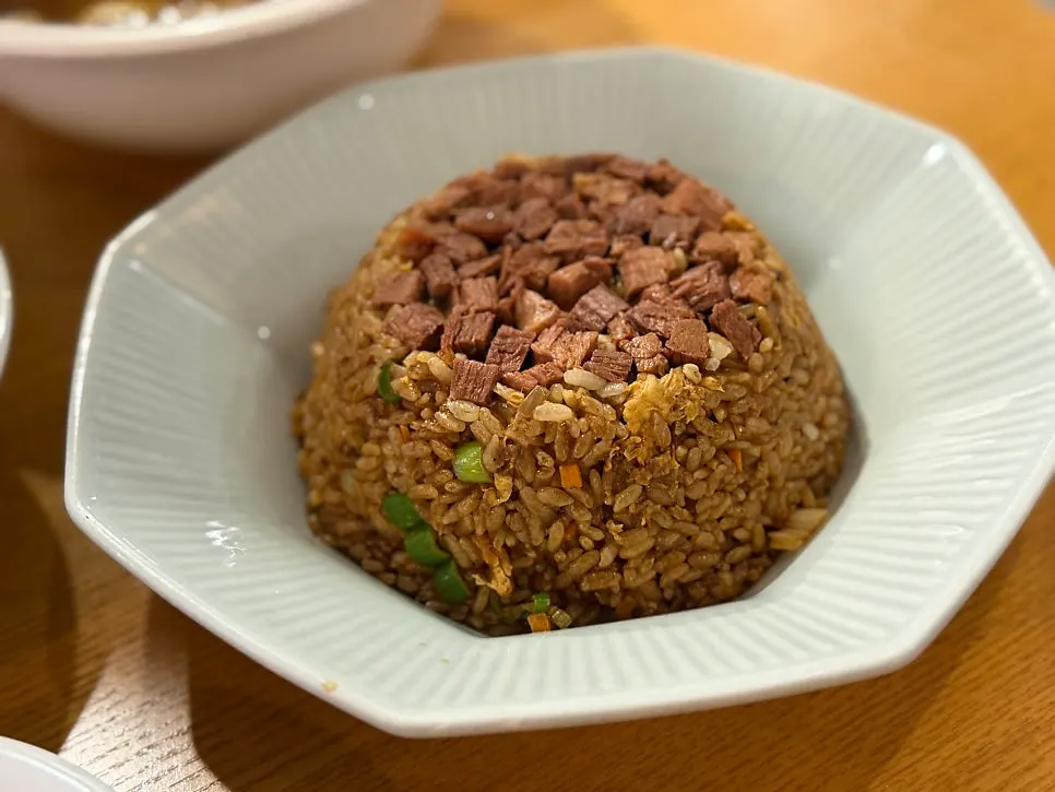 Beef fried rice piled high with beef on top