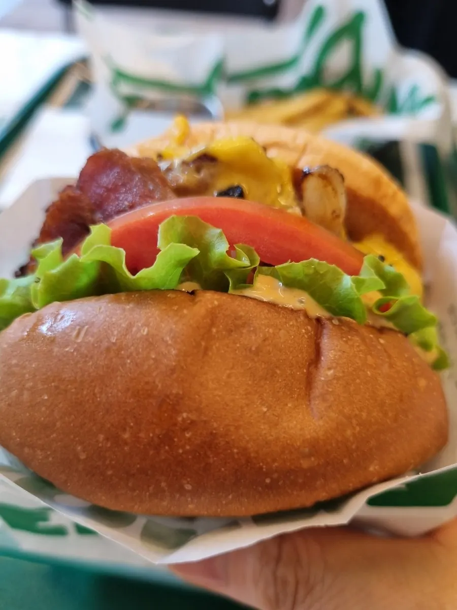 Holding a Burgiz Daeheung burger by hand