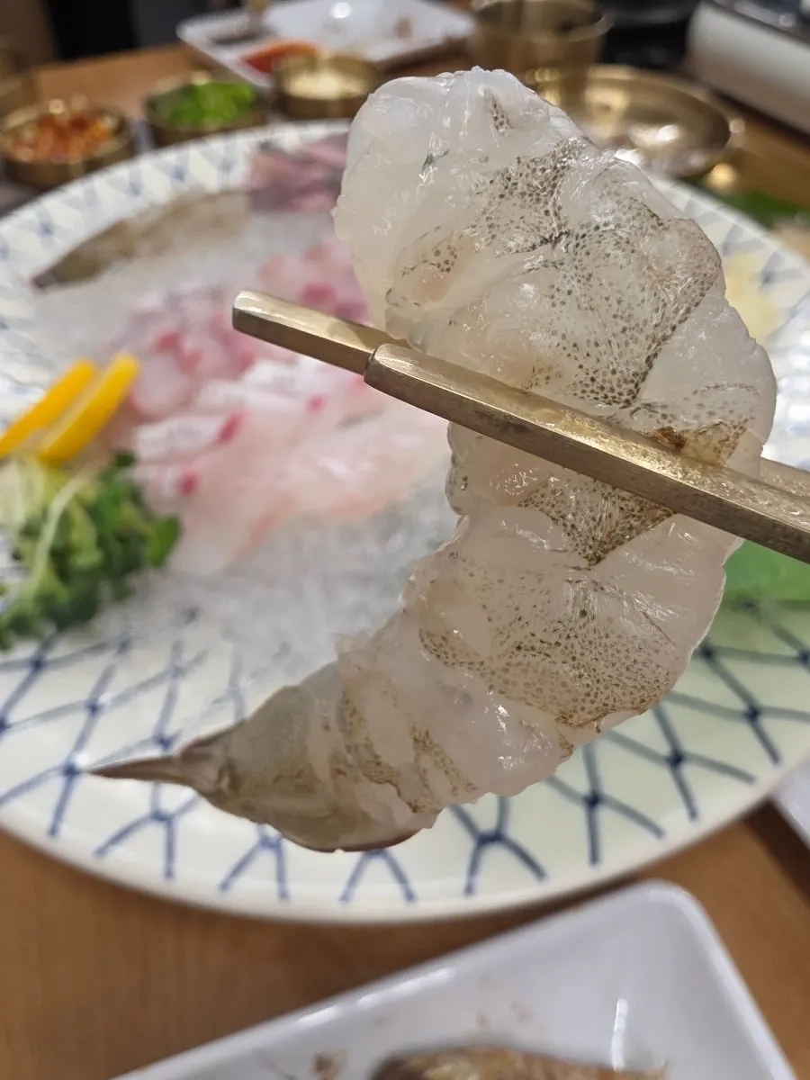 Close-up of a single piece of raw shrimp sashimi