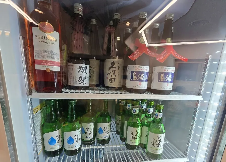 Restaurant fridge stocked with a variety of alcoholic drinks