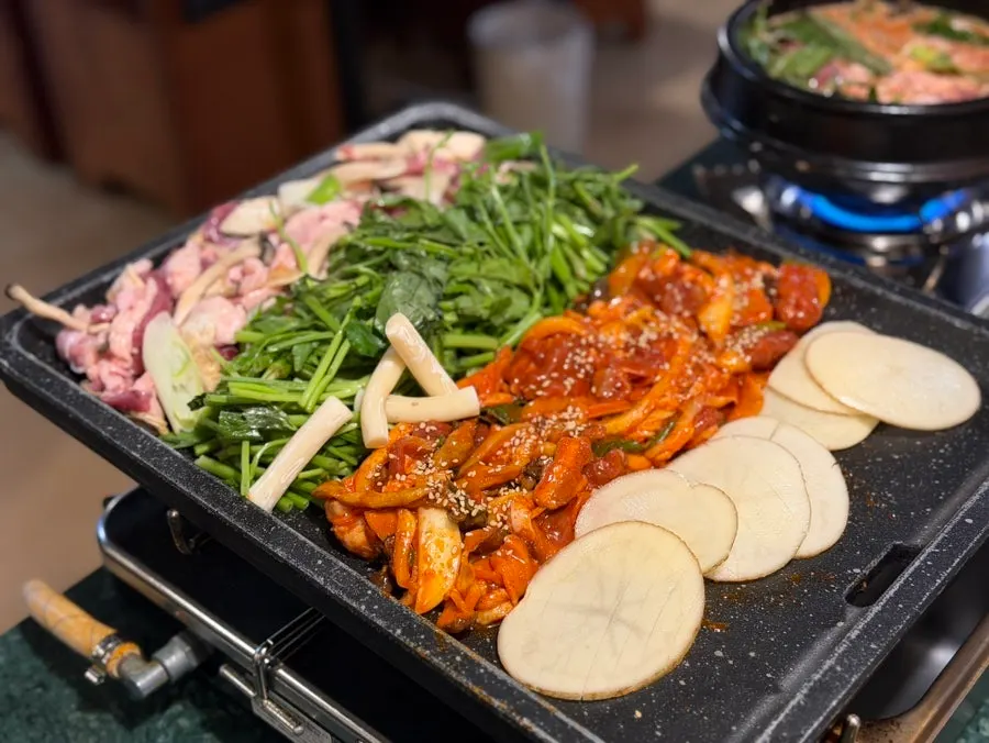 Duck gamjatang and barley shrimp minari pancake spread near Daeheung Station, Gongjung Dodeok