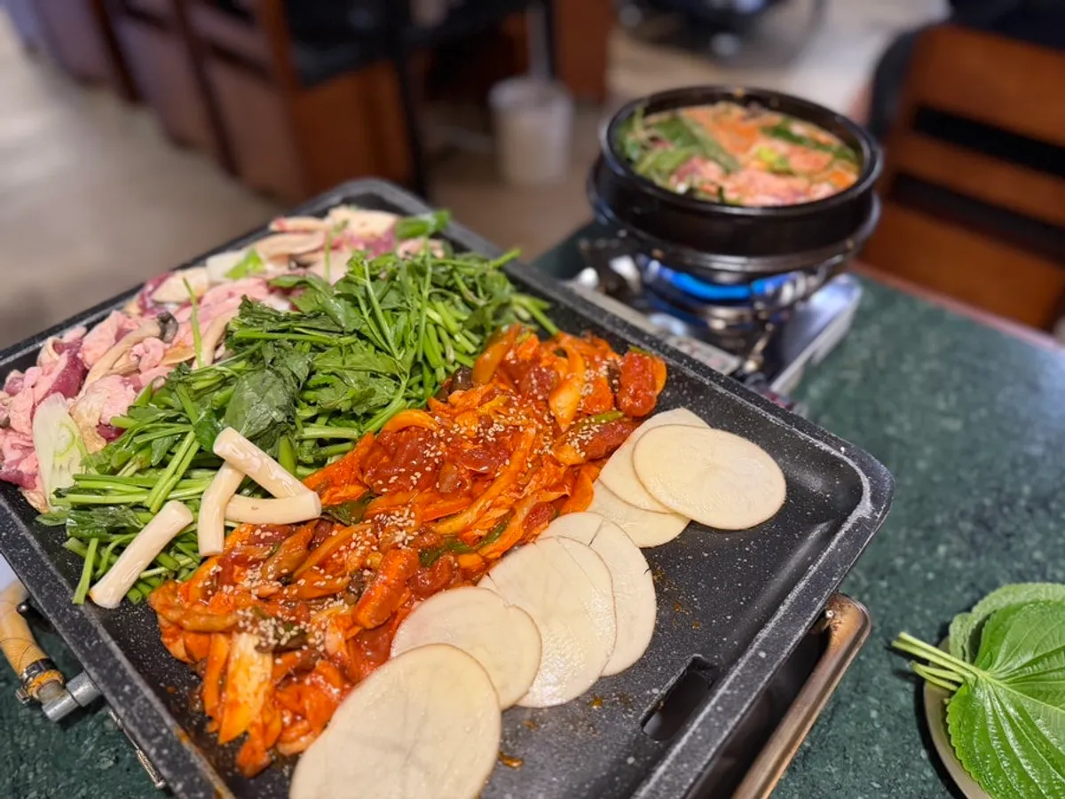 Grill plate with duck roast, jumulleok, minari, and potatoes