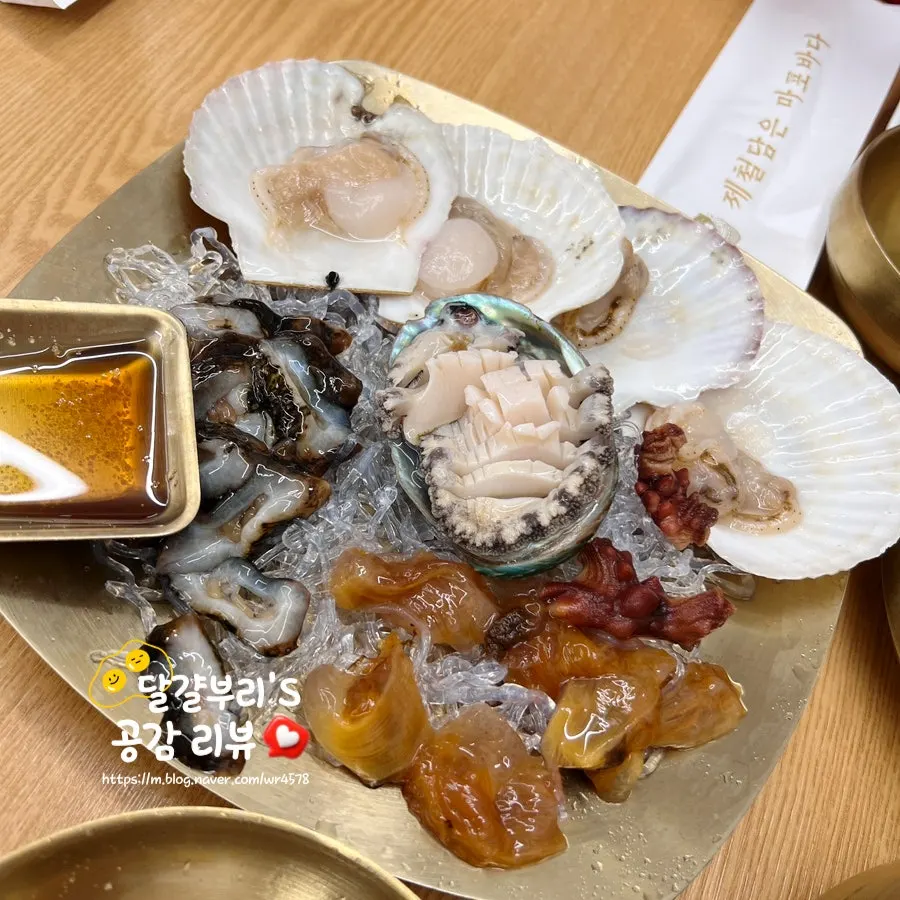 전복과 가리비가 올라간 해산물모듬 접시