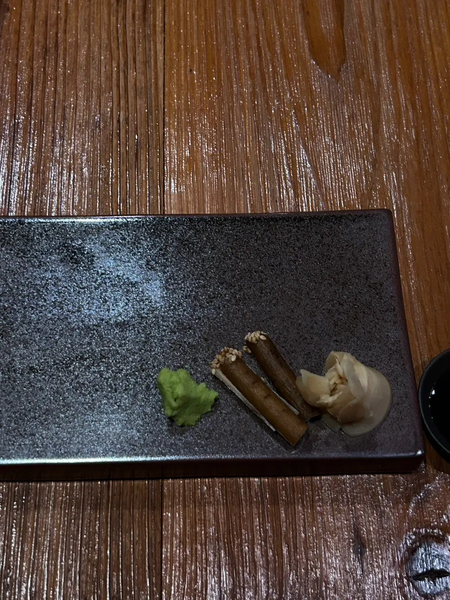 Place setting with green tea, wasabi, and burdock