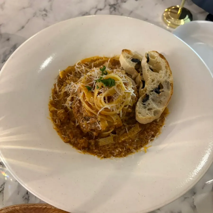Flat pasta noodles coated in ragu sauce