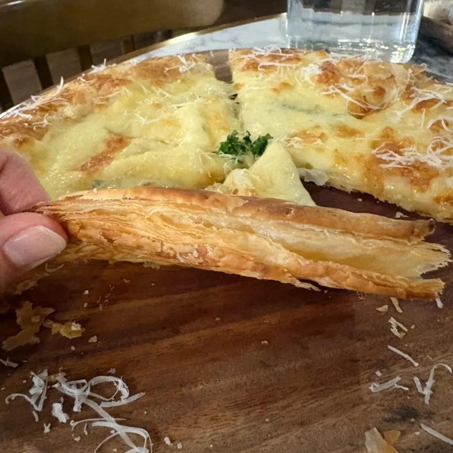 A crispy slice of the pastry-dough pizza