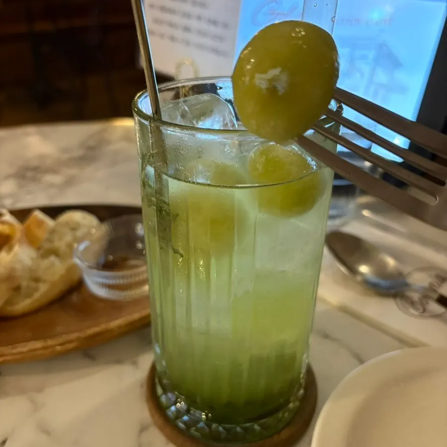 Green grape ade alongside the meal spread