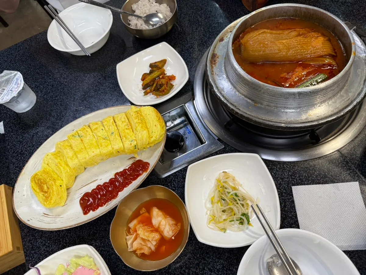 Giant rolled omelet served with kimchi stew