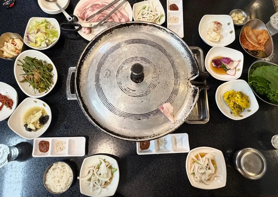 Side dishes including kimchi and scallion salad