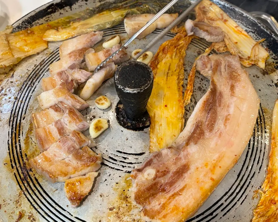Thick fresh pork belly and a cast-iron lid